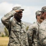 Military trainer giving training to a saluting military soldier in military uniform representing how PCA serves clients within the United States Military & Department of Defense (DoD)