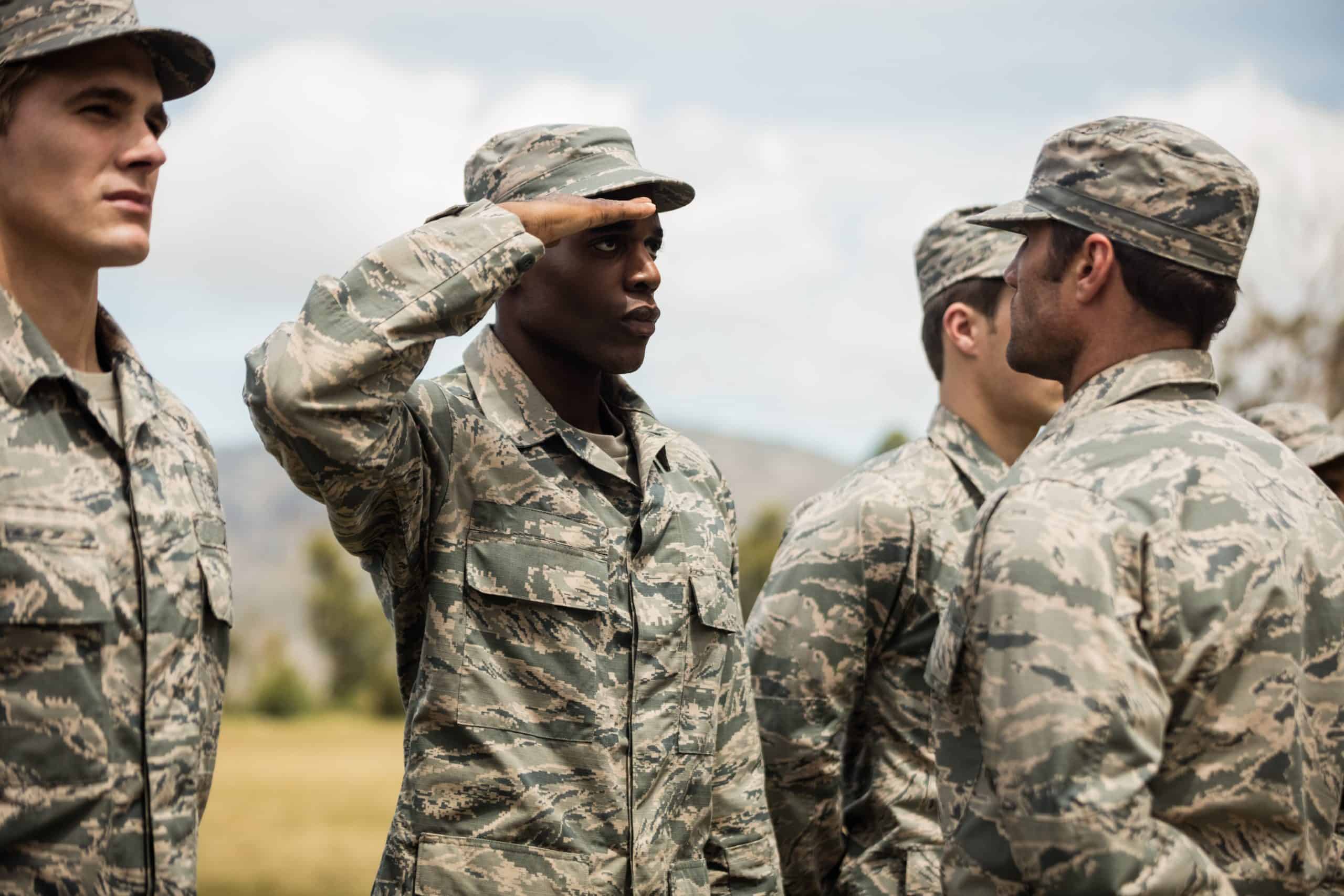 Military trainer giving training to a saluting military soldier in military uniform representing how PCA serves clients within the United States Military & Department of Defense (DoD)